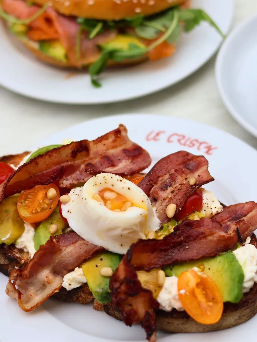 Assiette de brunch avec œuf poché, bacon et avocat servie au Cristal